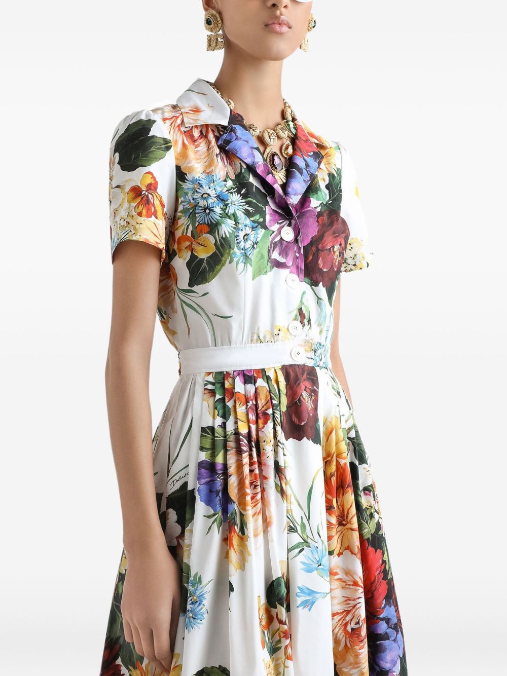 Woman wearing a colorful floral dress on a white background