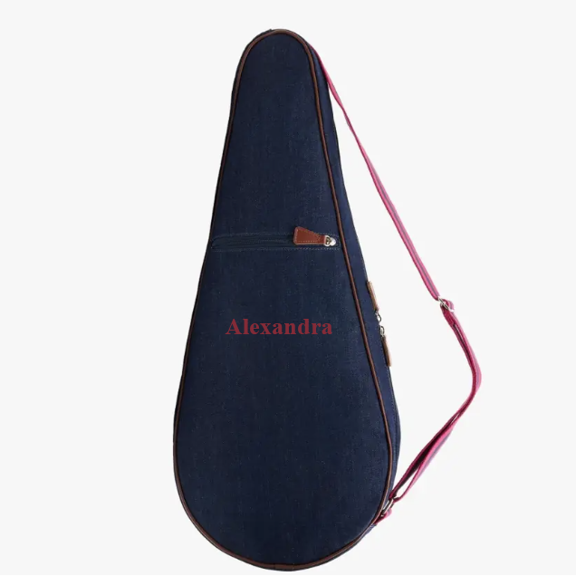 A dark navy blue guitar or ukulele case with a pink strap and a pink personalized name &